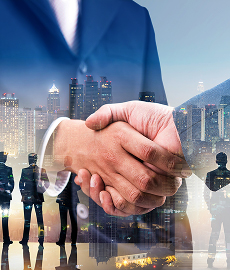 Business handshake symbolizing trust and partnership in reinsurance solutions, with a cityscape overlay representing Samsung Reinsurance’s global expertise and financial strength.